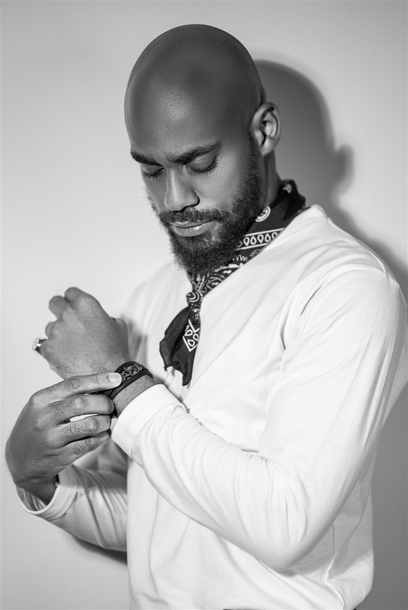 Black and white close-up of Moceol adjusting a wrist cuff
