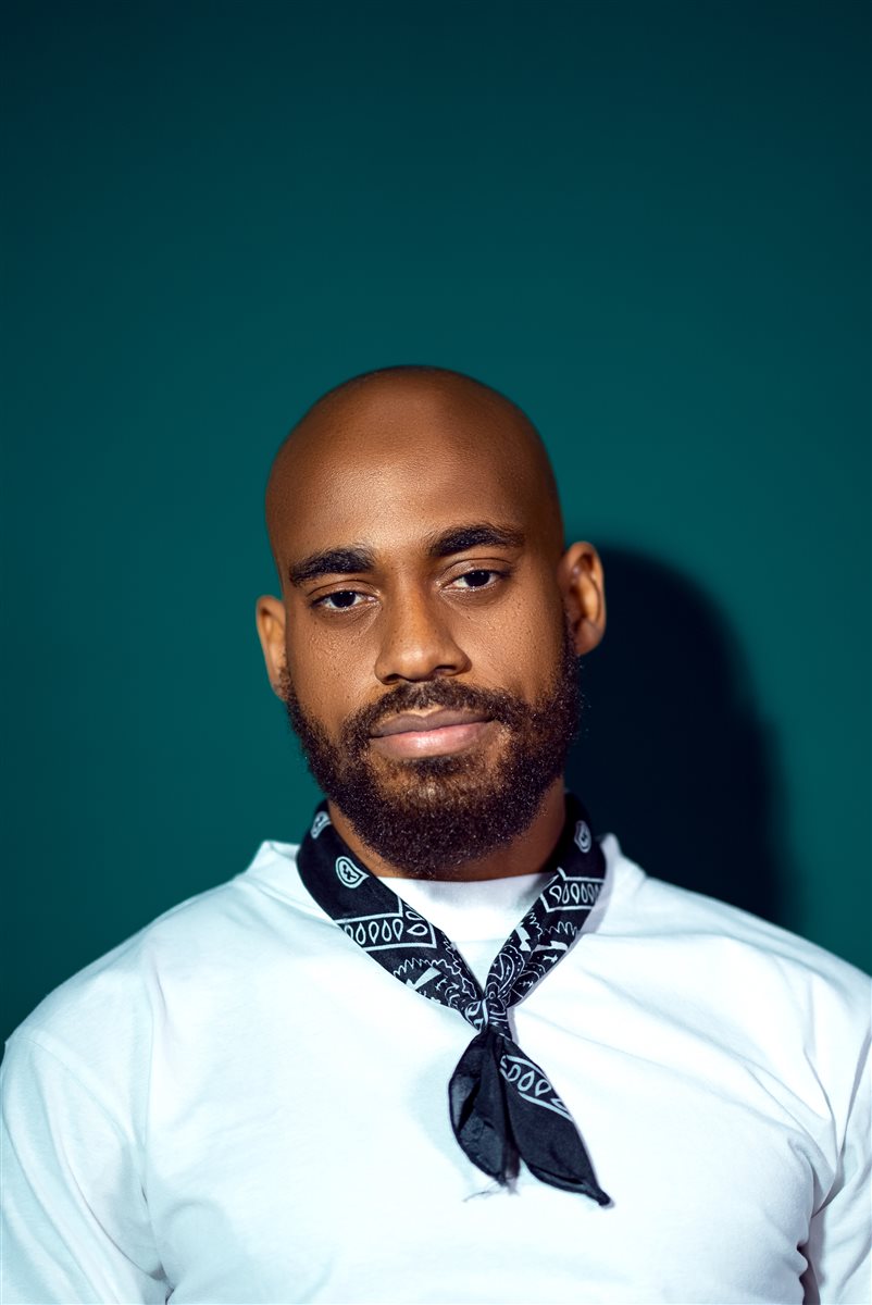 Moceol portrait against a solid teal backdrop